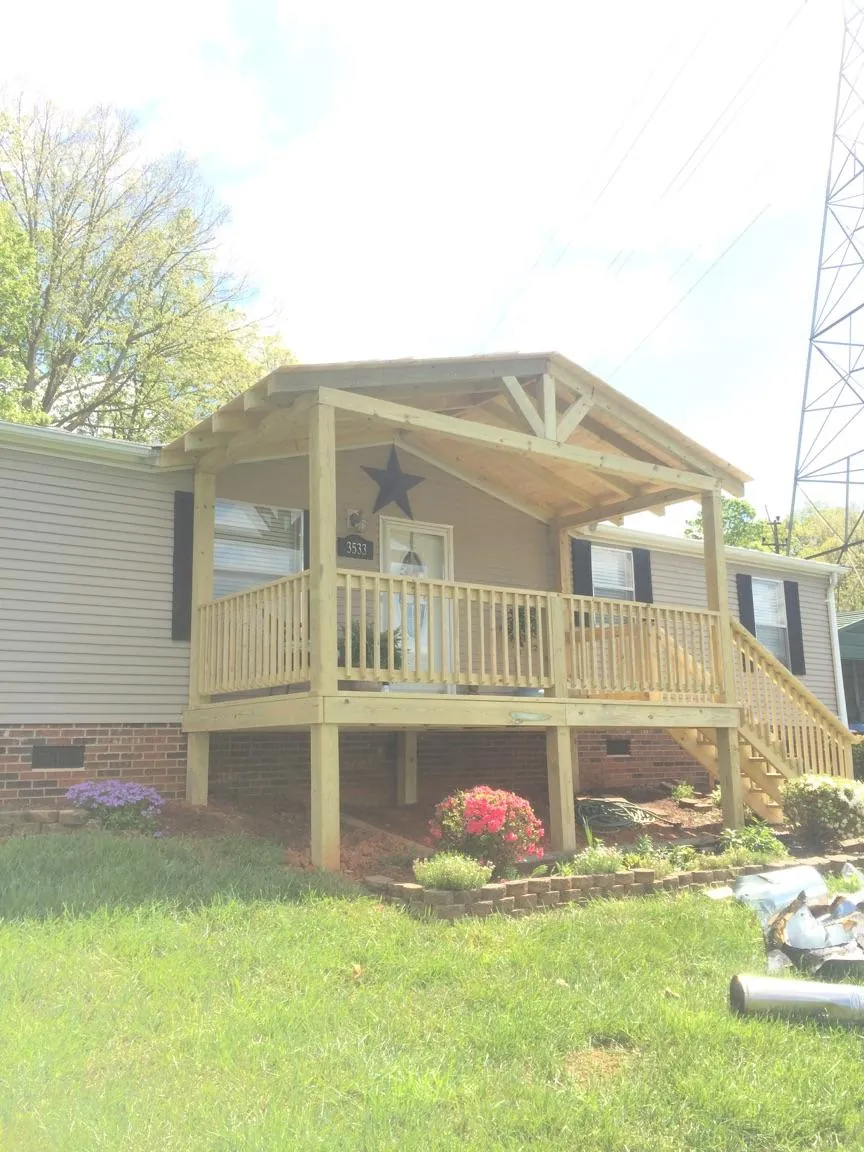 New gabled porch roof and deck railing added to a ranch home in Bee